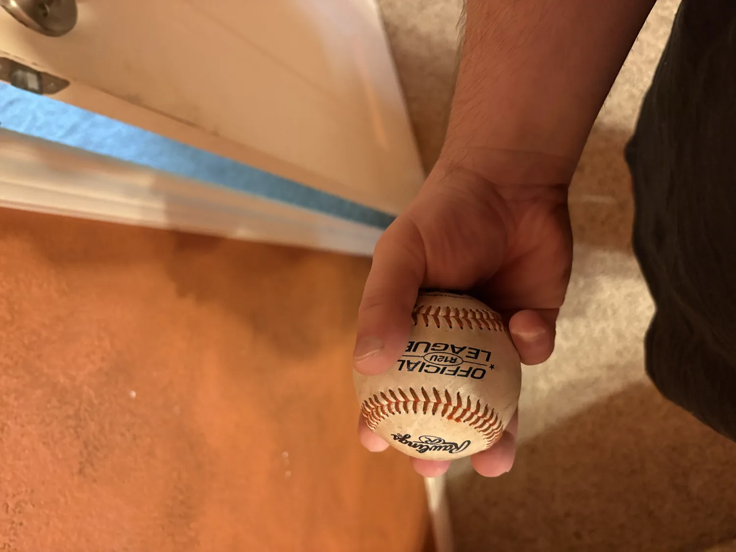 A side view of a three-finger changeup grip.