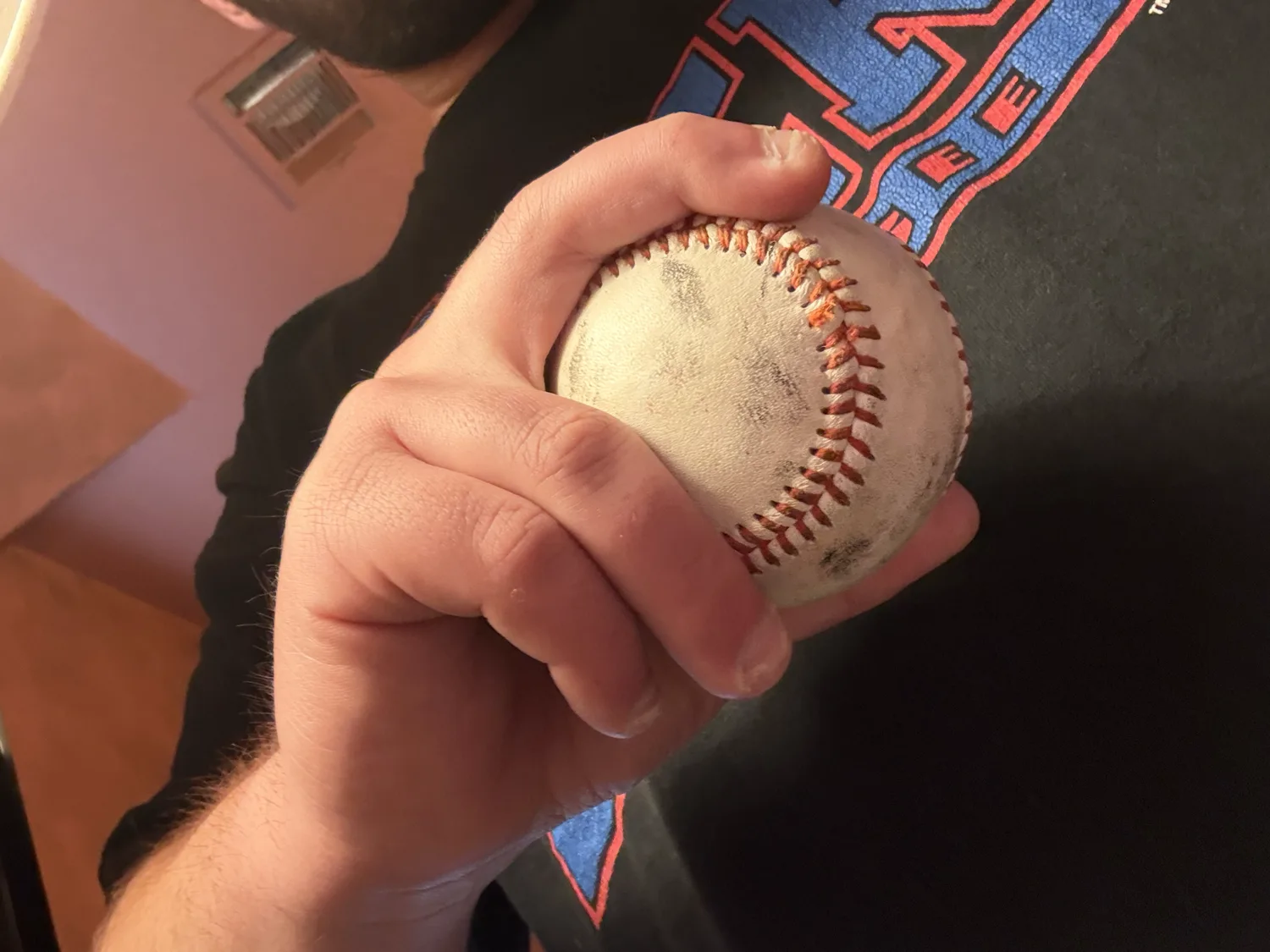 A 12-6 curveball grip held in the hand, the fingers bent over the seam.
