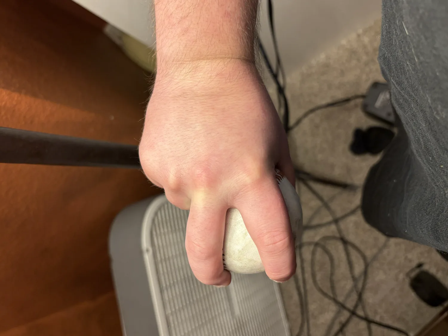 The underside of a two-seam grip, the thumb supporting from below.